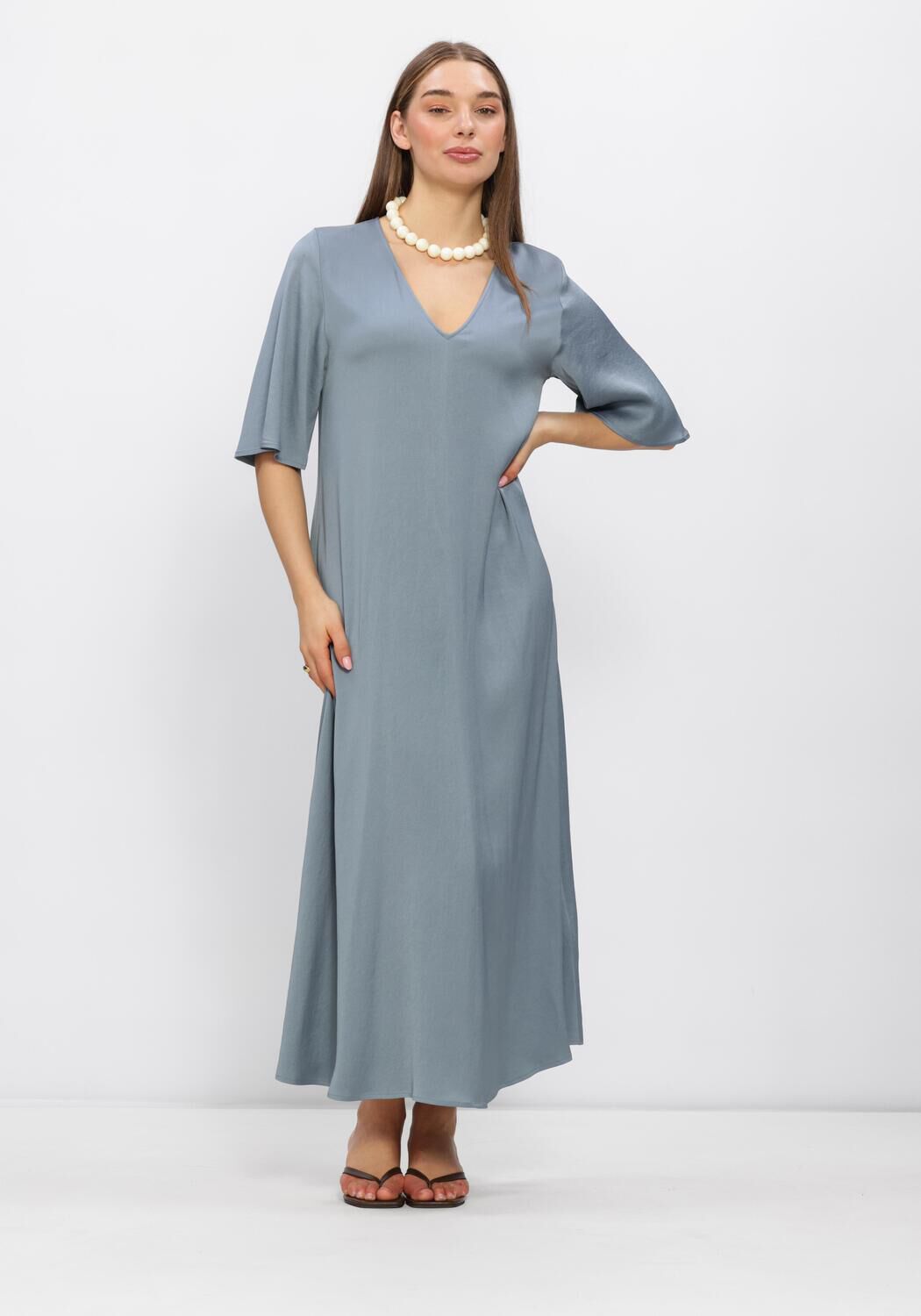 Pink Baby Aurélia V-Neck Flowing Maxi Dress in Dusty Blue, featuring a soft, flowing fabric and elegant V-neck design.