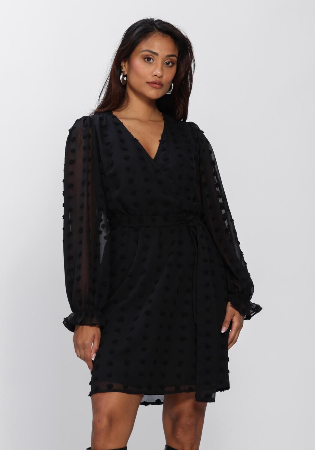 Black Emmanuelle Dobby Wrap Mini Dress by Pink Baby, showcasing the stylish wrap design and elegant fabric details.