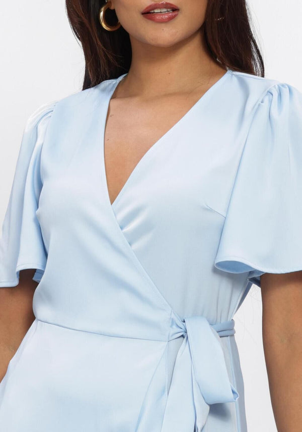 Pink Baby Livina ruffle-hem wrap midi dress in powder blue, featuring a flowy design and elegant ruffle details.