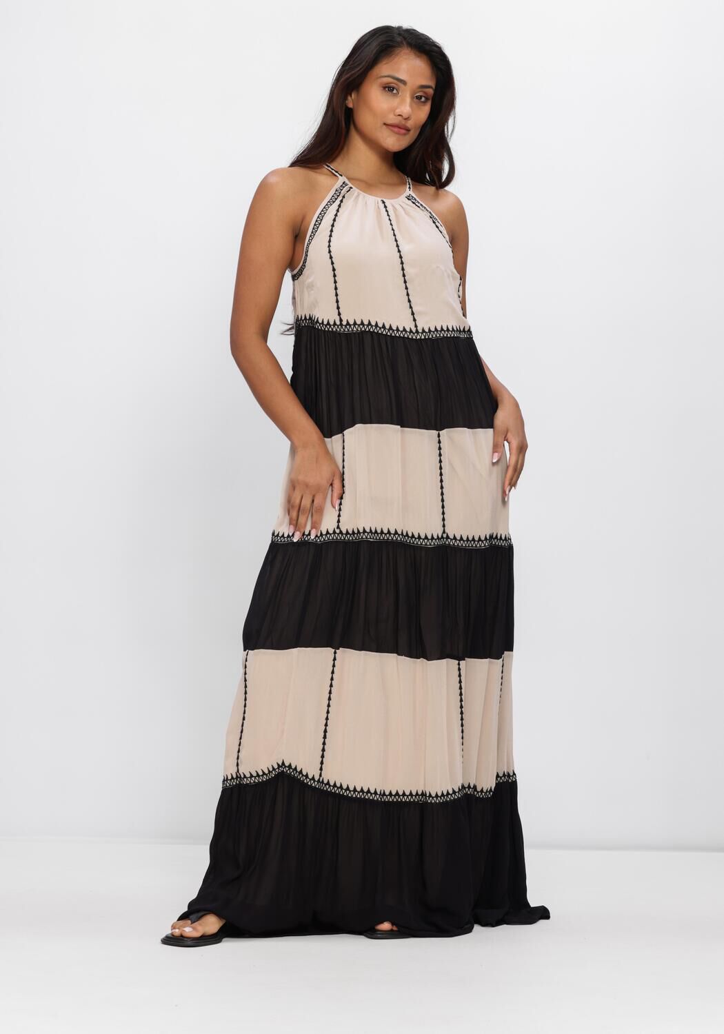 Beige and black Adorn Tassel-Tie Tiered Maxi Dress by Pink Baby with tassel tie and layered tiered design, full-length view.