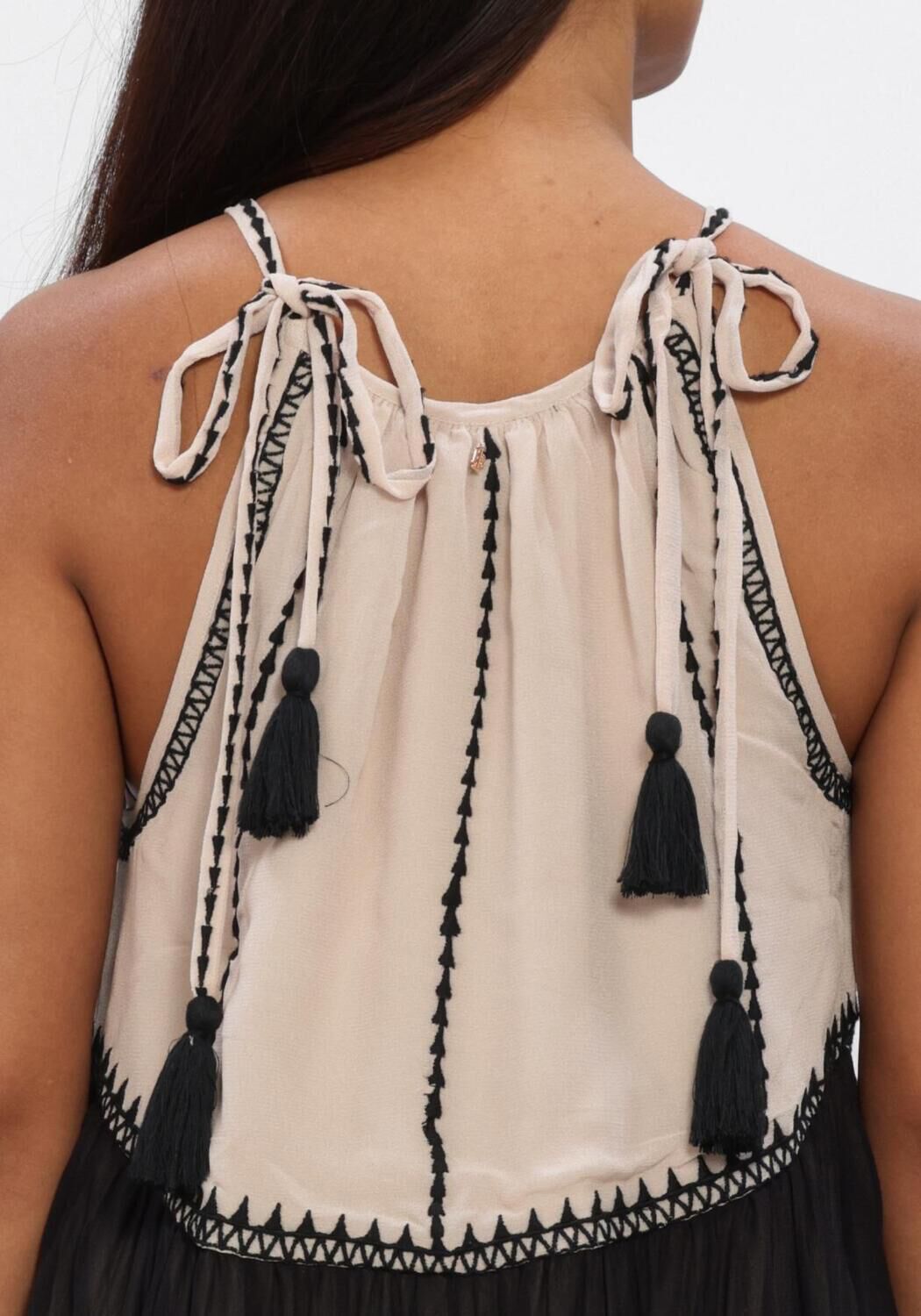 Pink Baby beige and black Adorn Tassel-Tie Tiered Maxi Dress hanging on a mannequin with tassel details and tiered design.