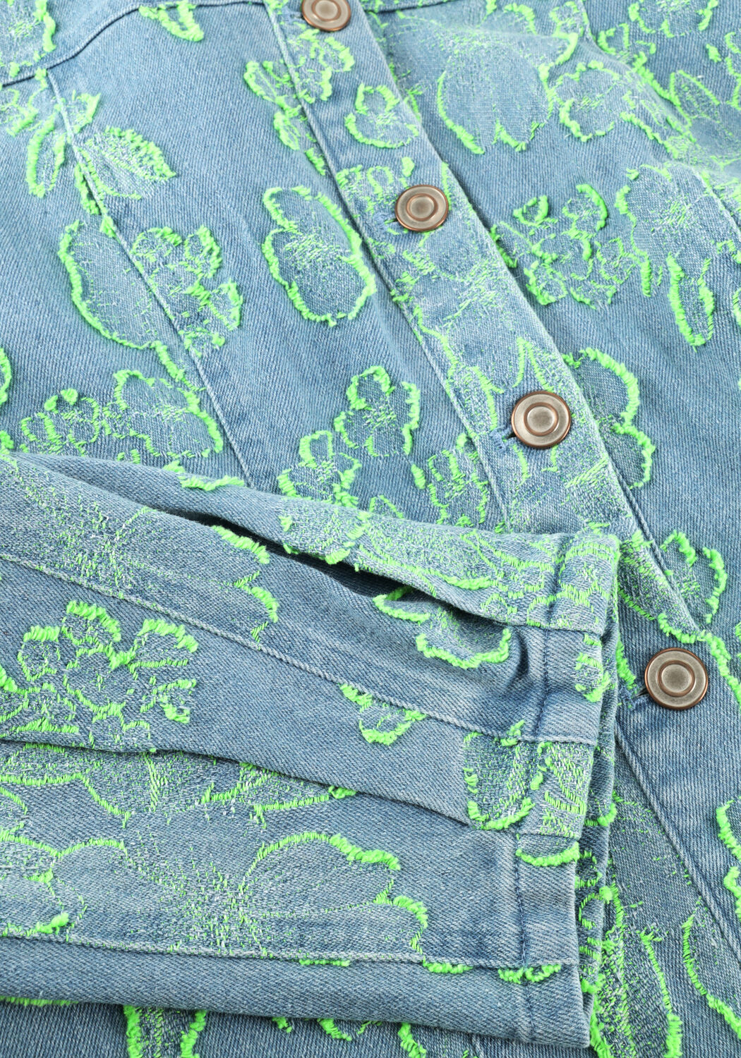 Pink Baby Freya floral denim mini dress in blue and green with a casual fit and colorful floral pattern.