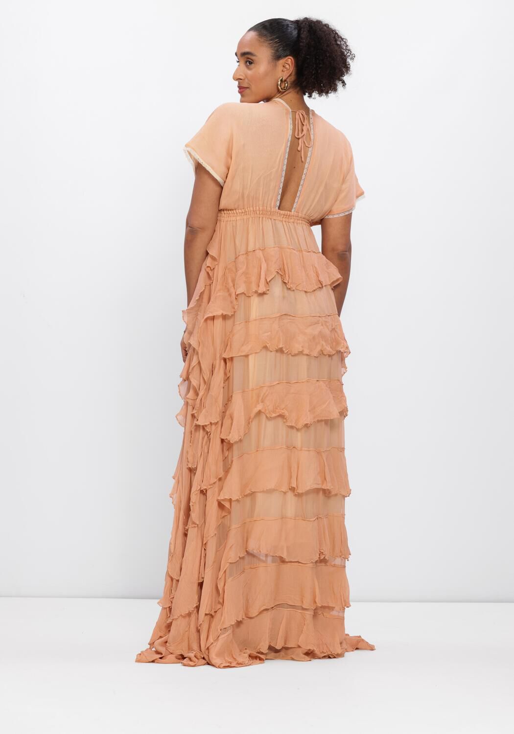 Pink Baby Amara tiered ruffle maxi dress in peach, featuring flowing fabric and layered ruffle design for a stylish look.