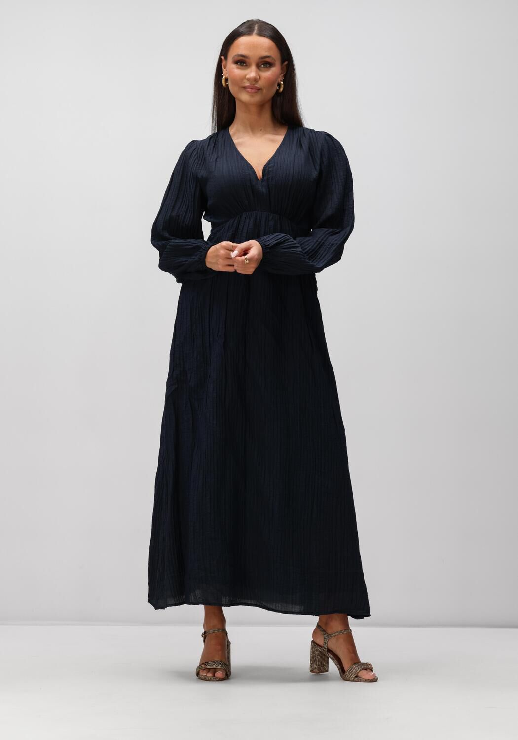 Pink Baby Serena textured V-neck maxi dress in midnight blue, featuring elegant fabric and flowing silhouette.