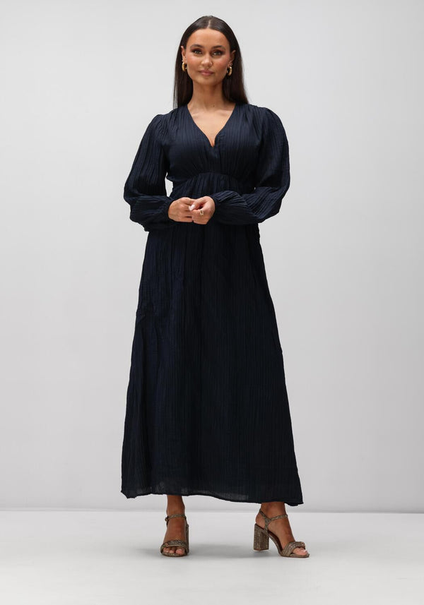 Pink Baby Serena textured V-neck maxi dress in midnight blue, featuring elegant fabric and flowing silhouette.