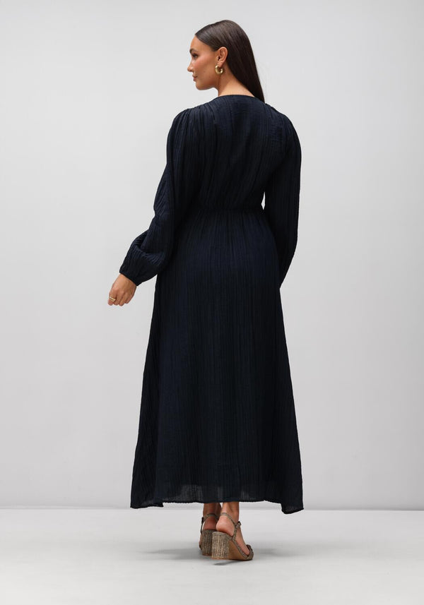 Pink Baby Serena textured V-neck maxi dress in midnight blue, featuring a flowing silhouette and elegant design.