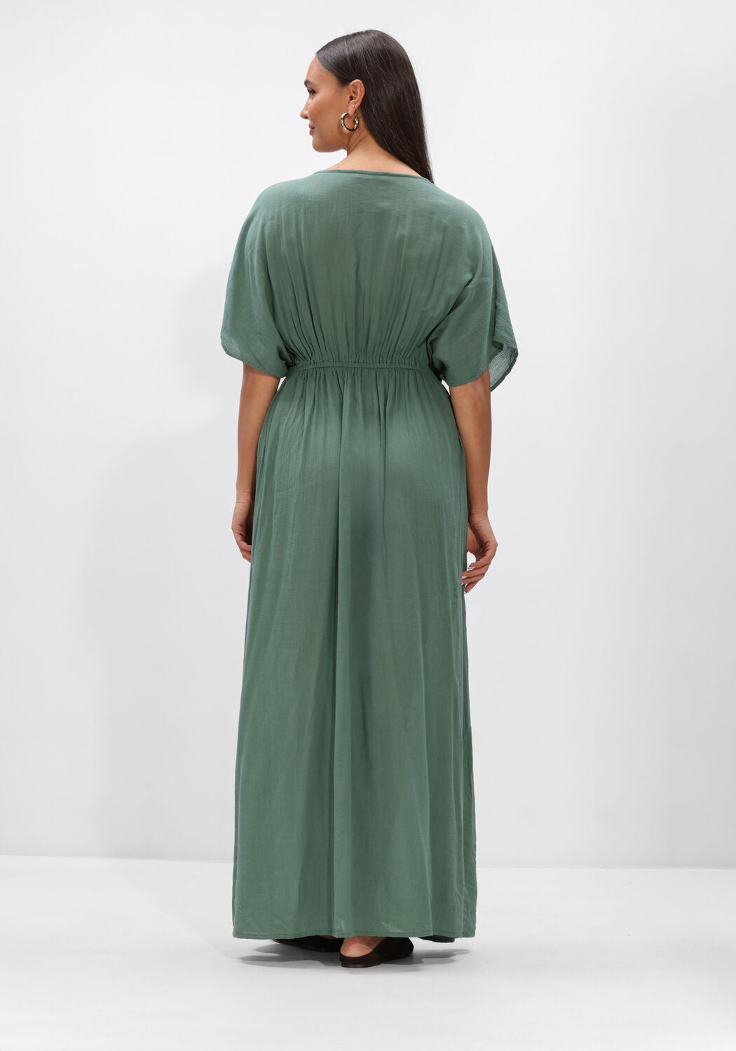 Pink Baby Livia drawstring empire maxi dress in sage green, flowing fabric with a fitted waist and elegant design.