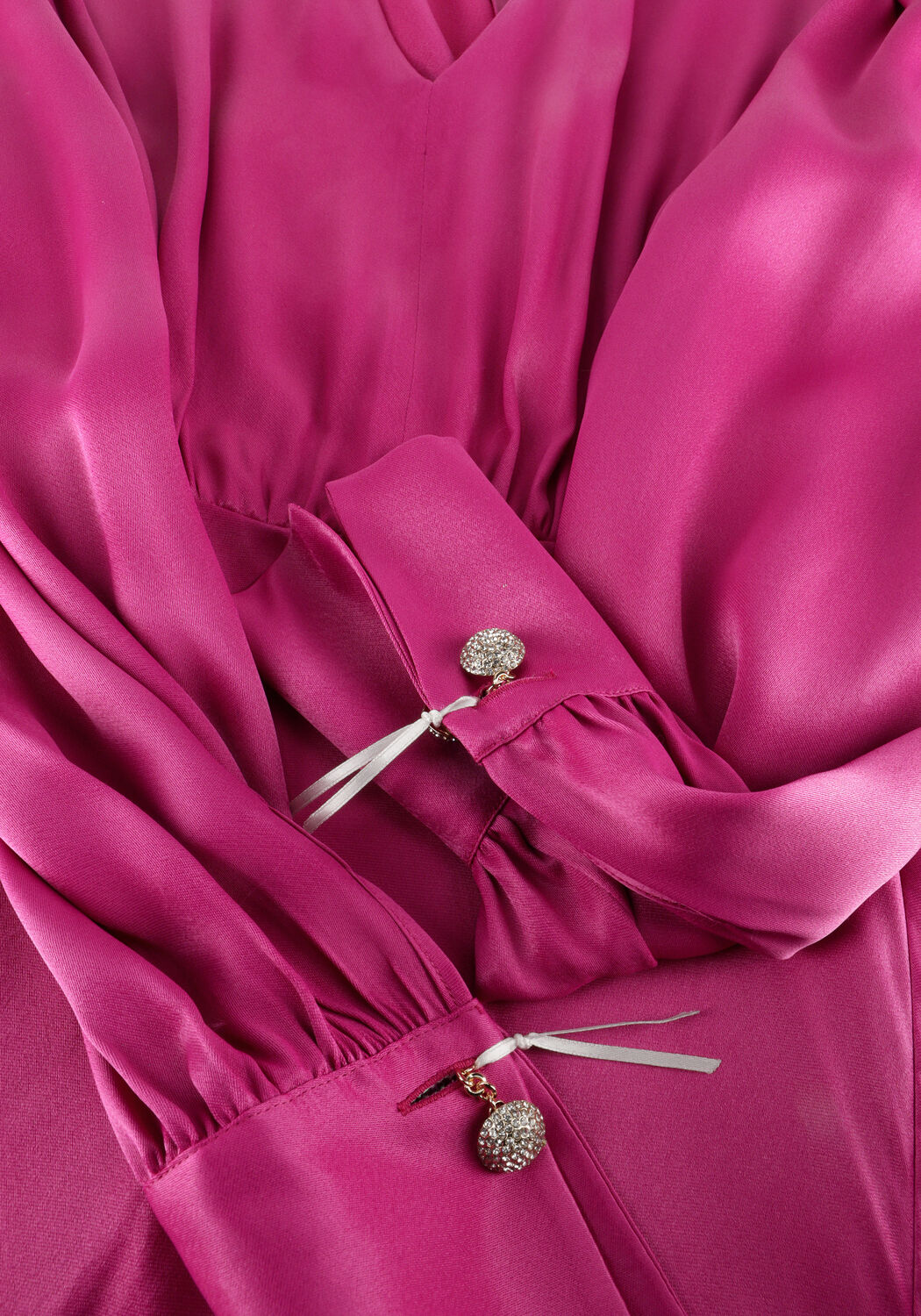 Pink Baby Fiorella satin V-neck maxi dress in vibrant fuchsia color, flowing fabric with elegant design and sleeveless style.