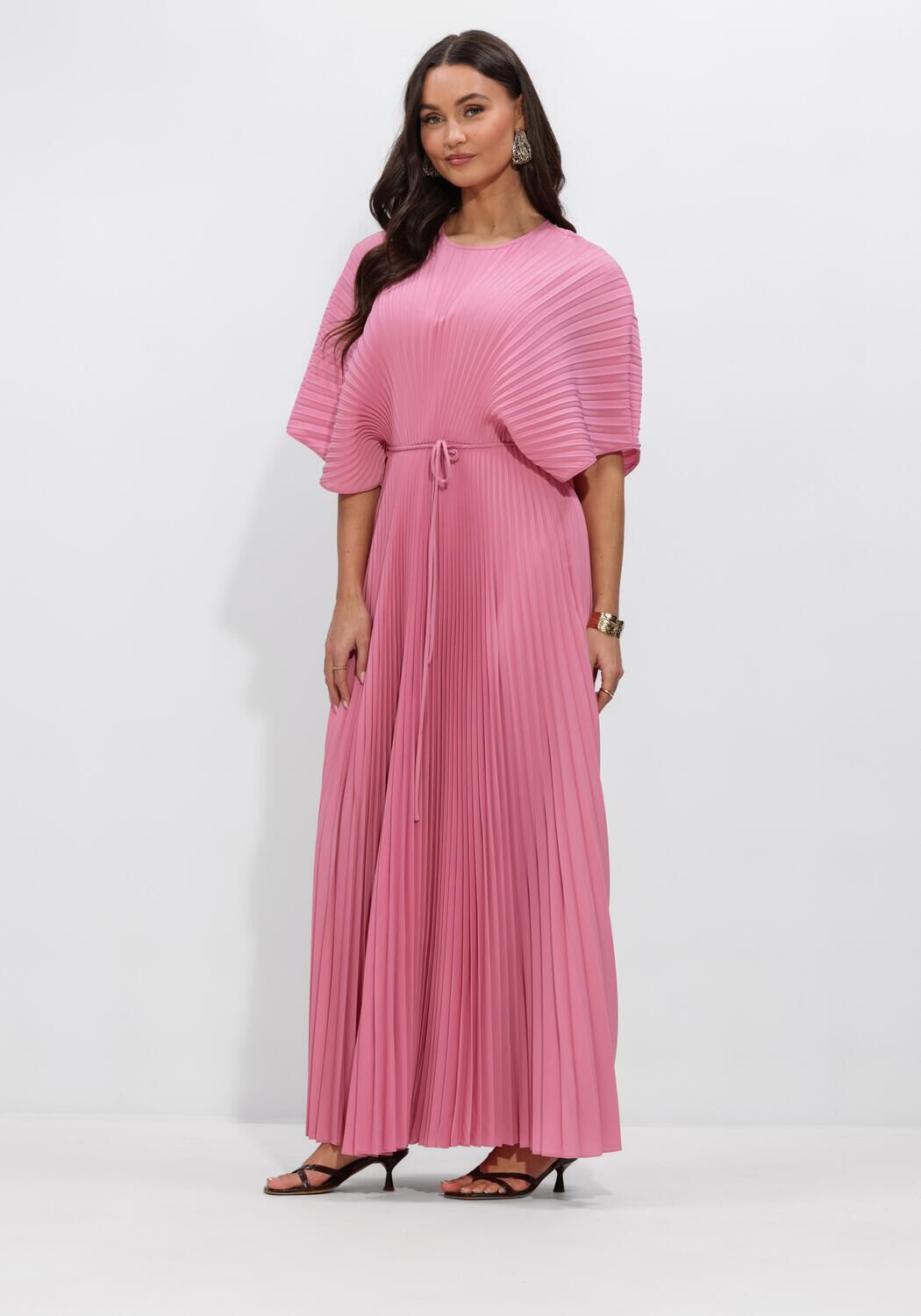 Pink Baby Rosalie pleated cape-sleeve maxi dress in vibrant pink, shown on a model with flowing fabric and stylish design.