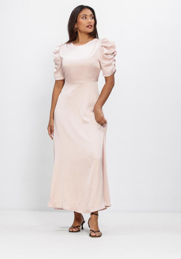 Pink Baby Maxine Satin Puff Sleeve Maxi Dress in blush, featuring elegant puff sleeves and flowing fabric.