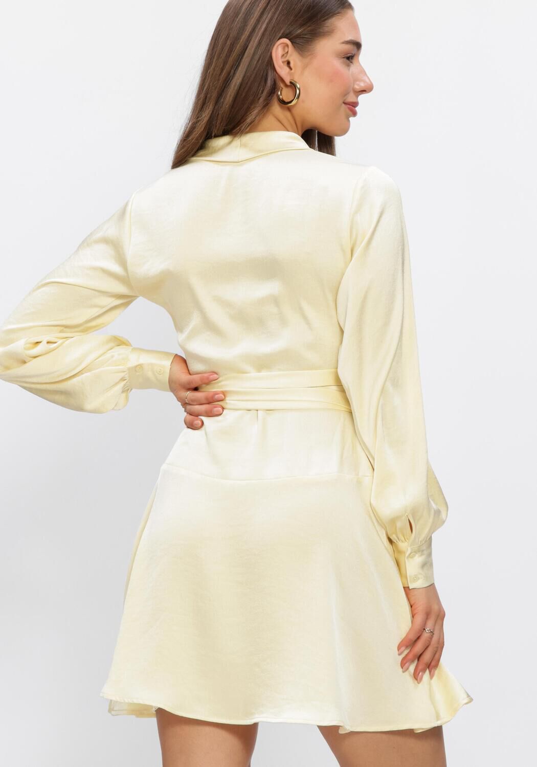 Pink Baby Elissa Satin Wrap Mini Dress in soft vanilla color, featuring a satin fabric and wrap design, shown on a model.