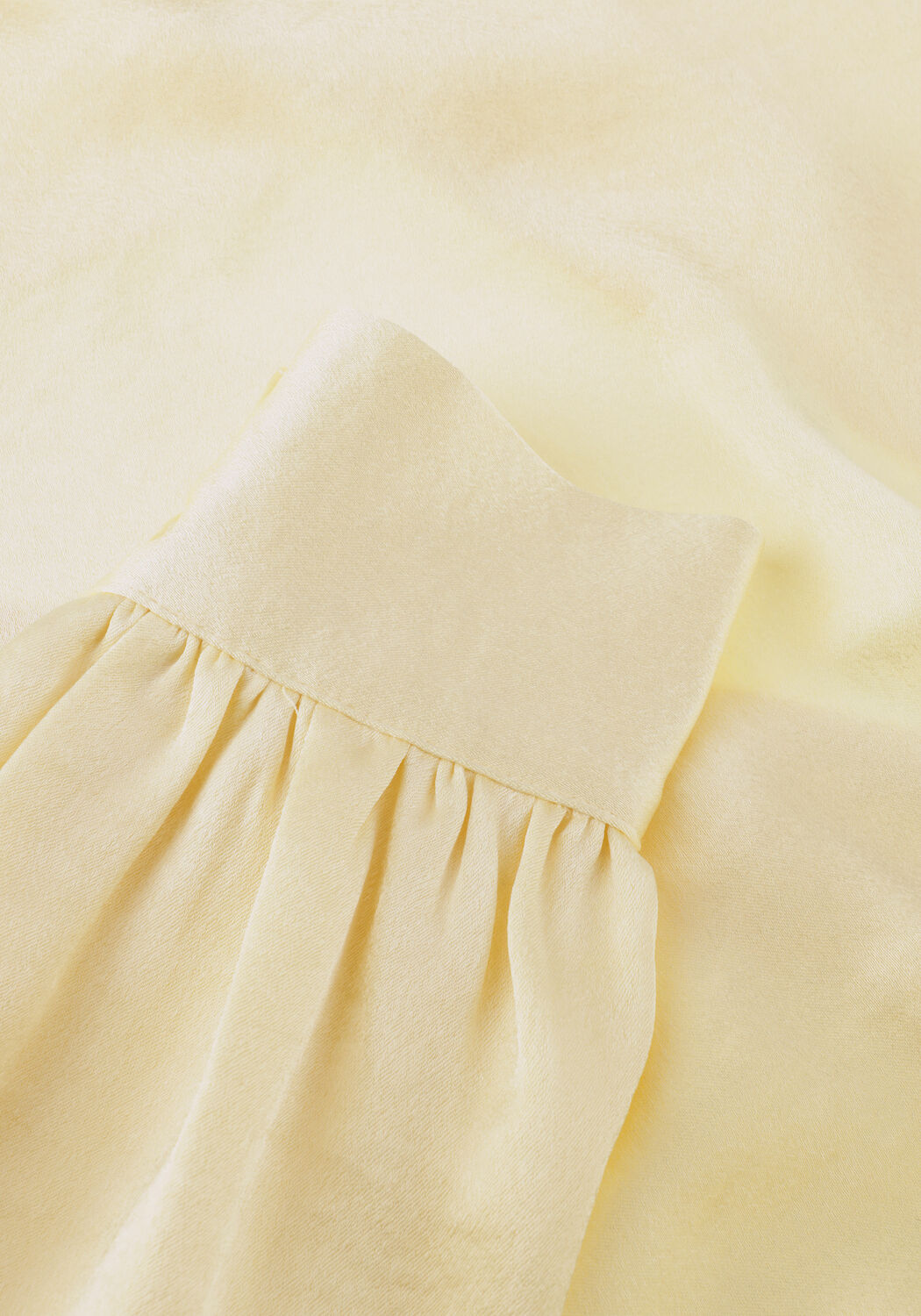 Pink Baby Elissa Satin Wrap Mini Dress in Soft Vanilla, showing a close-up of the elegant satin fabric and wrap design.