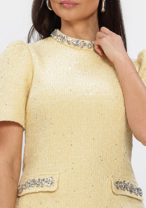 Pink Baby Celine embellished yellow tweed mini dress with decorative details, soft yellow color, and textured fabric.