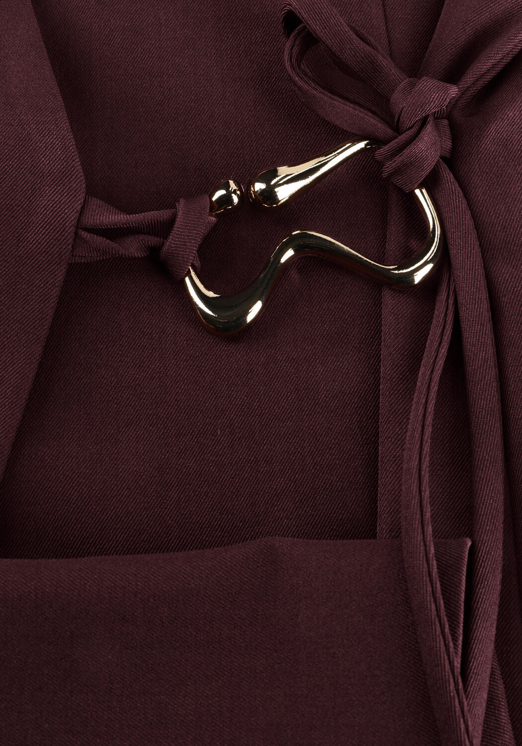 Pink Baby Viviana hardware wrap mini dress in burgundy, showing the fitted design and stylish hardware details.