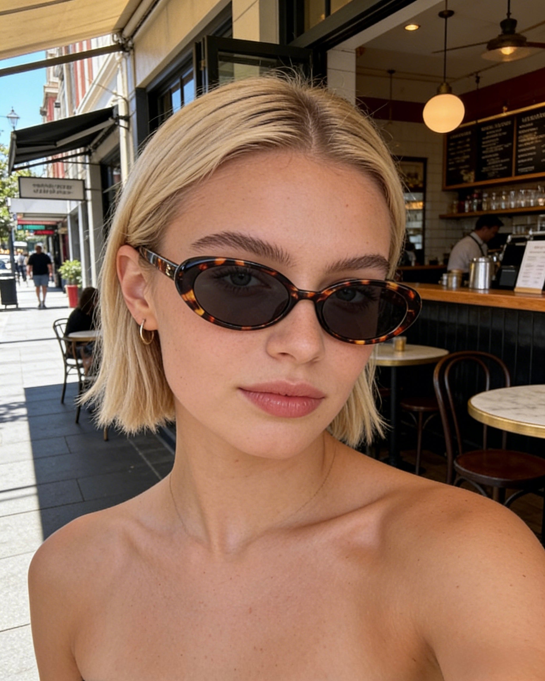 Pink Baby The Kyra tort sunglasses with round brown lenses and pink frame, stylish eyewear for sun protection.