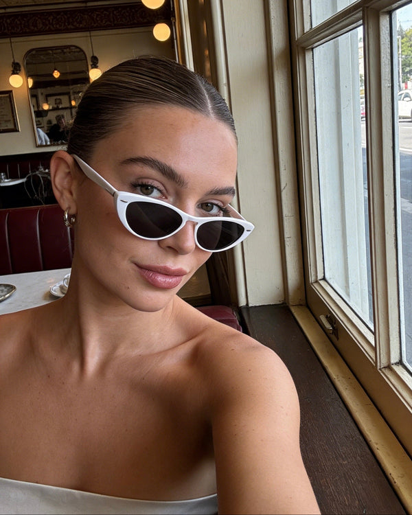 Pink Baby The Bailey white sunglasses with round frames and tinted lenses, stylish accessories for sunny days.