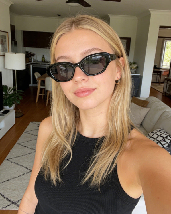 Pink Baby The Jamie black sunglasses with round frames and dark lenses, stylish eyewear for a trendy look.