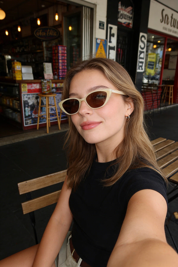 Pink Baby The Juno lemon sunglasses with yellow tinted lenses and round frames, stylish eyewear for sunny days.
