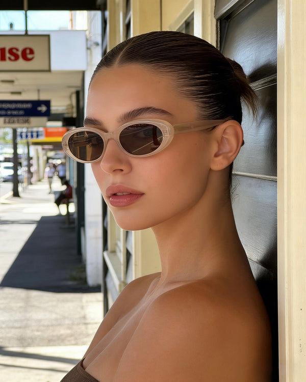 Pink Baby Kiara cinnamon sunglasses with round frames and tinted lenses, stylish and protective for sunwear fashion.