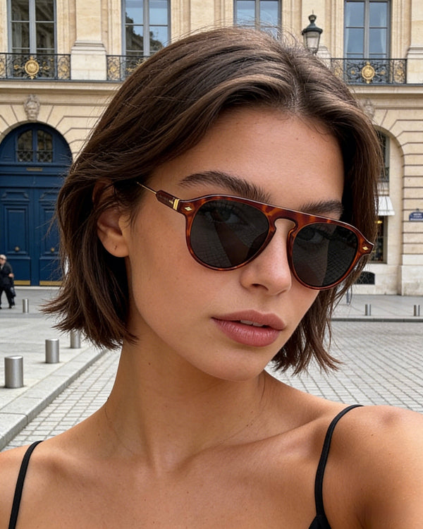 Pink Baby The Riley tortoise shell sunglasses with rounded frames and dark lenses, stylish accessory for sun protection.