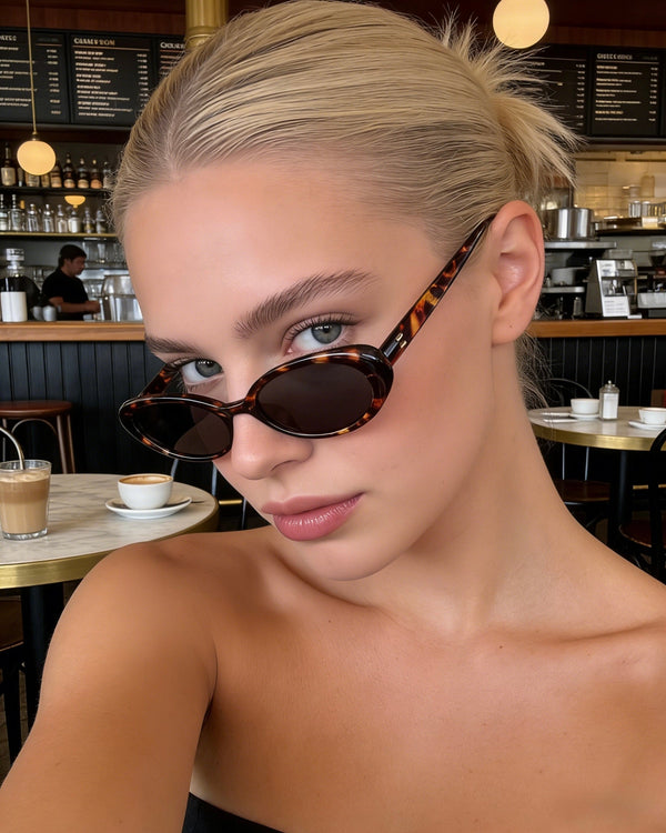 Pink Baby The Kyra tort sunglasses with round frames and dark lenses, stylish eyewear for fashion-forward looks.