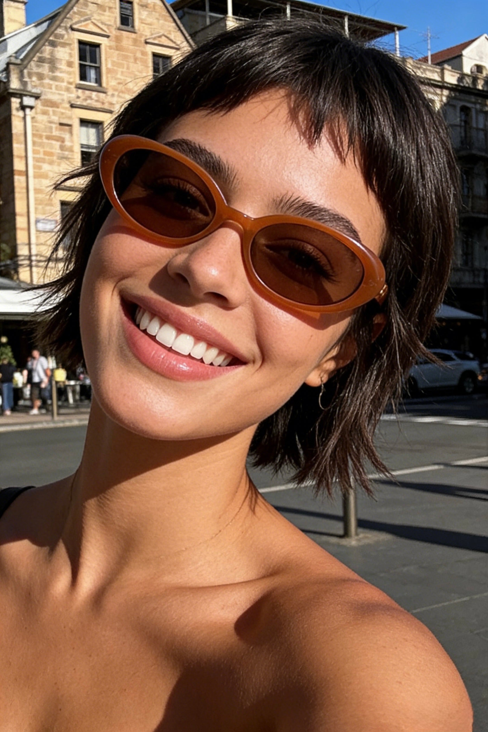 Pink Baby The Kyra pumpkin-shaped sunglasses with orange lenses and black frames, stylish and playful for kids.