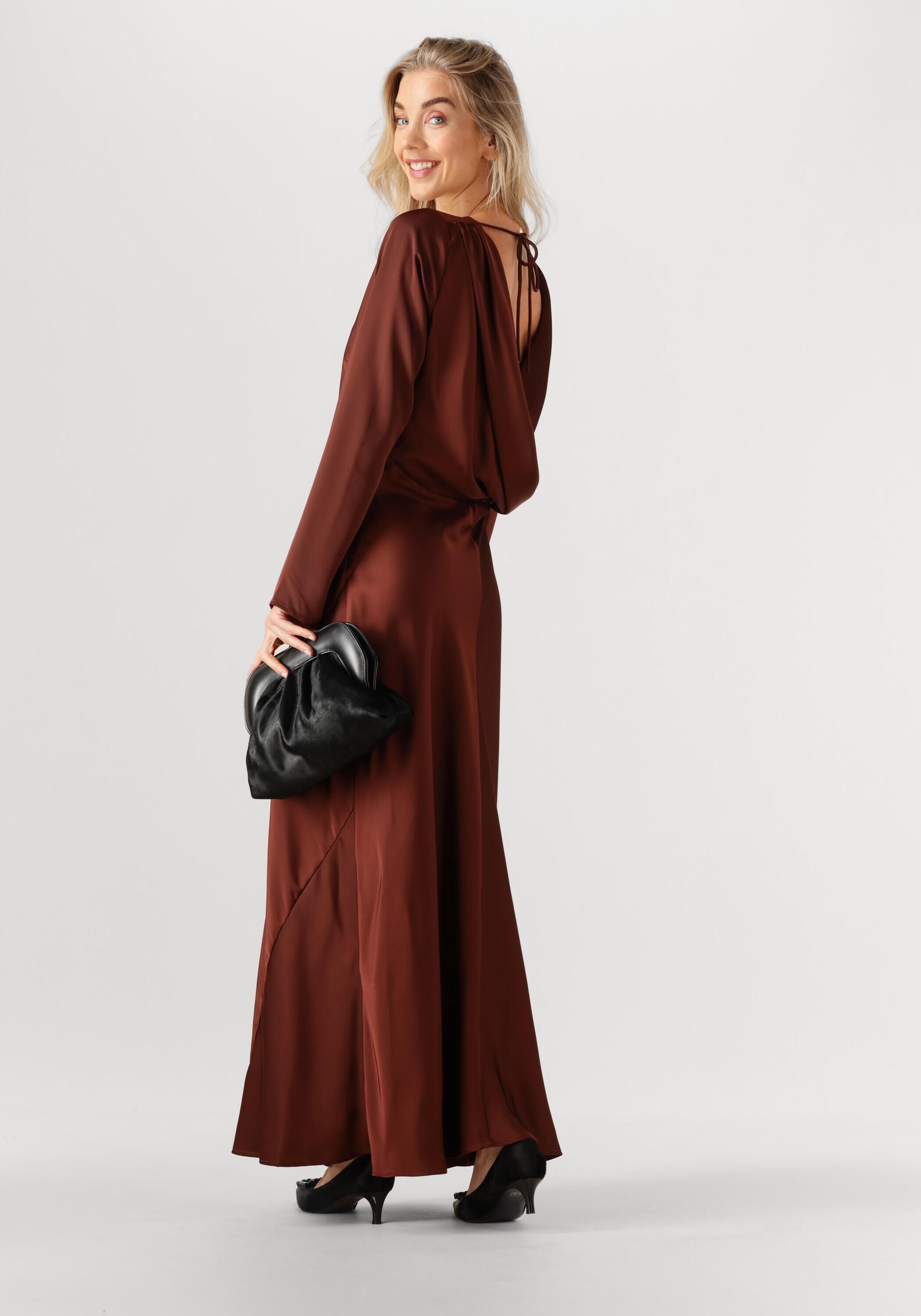 Pink Baby Burgundy Aurélie open-back satin maxi dress displayed on a model with flowing fabric and elegant design.