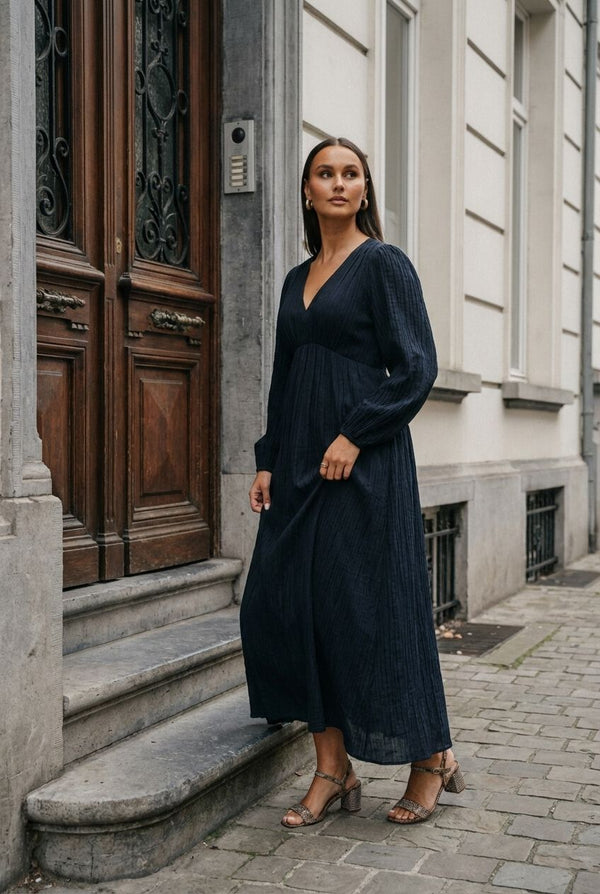 Pink Baby Serena textured V-neck maxi dress in midnight blue, showcasing a flowing fabric and elegant silhouette.