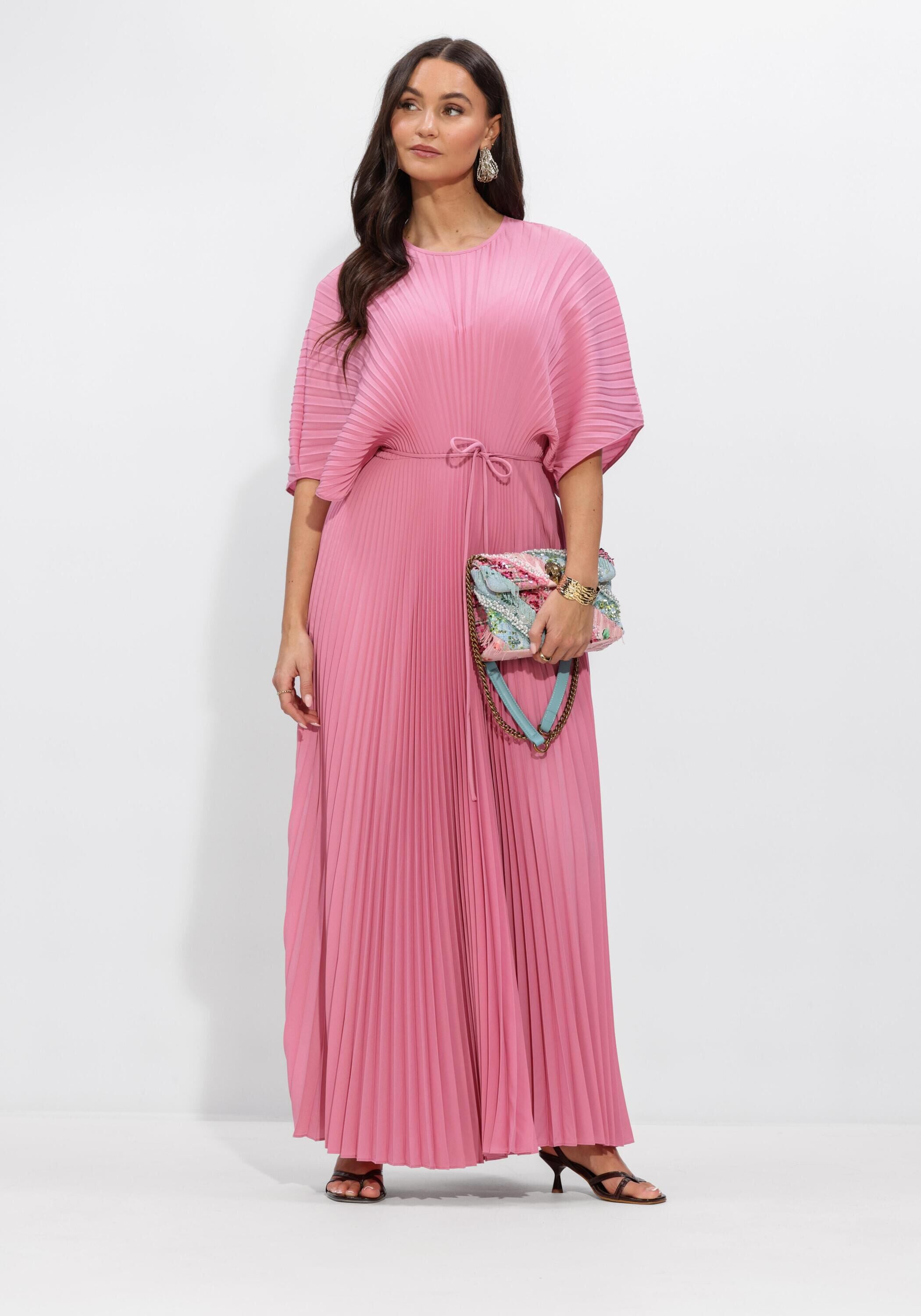 Pink Baby Rosalie Pleated Cape-Sleeve Maxi Dress in pink, shown on a model with flowing fabric and elegant cape sleeves.