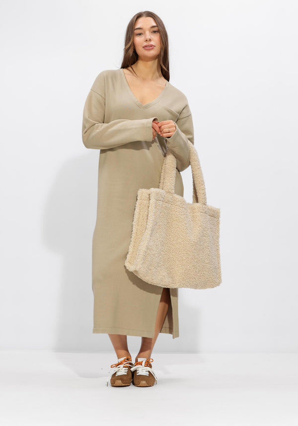 Pink Baby Elaine relaxed V-neck midi dress in sand beige, shown on model, featuring flowy fabric and midi length.