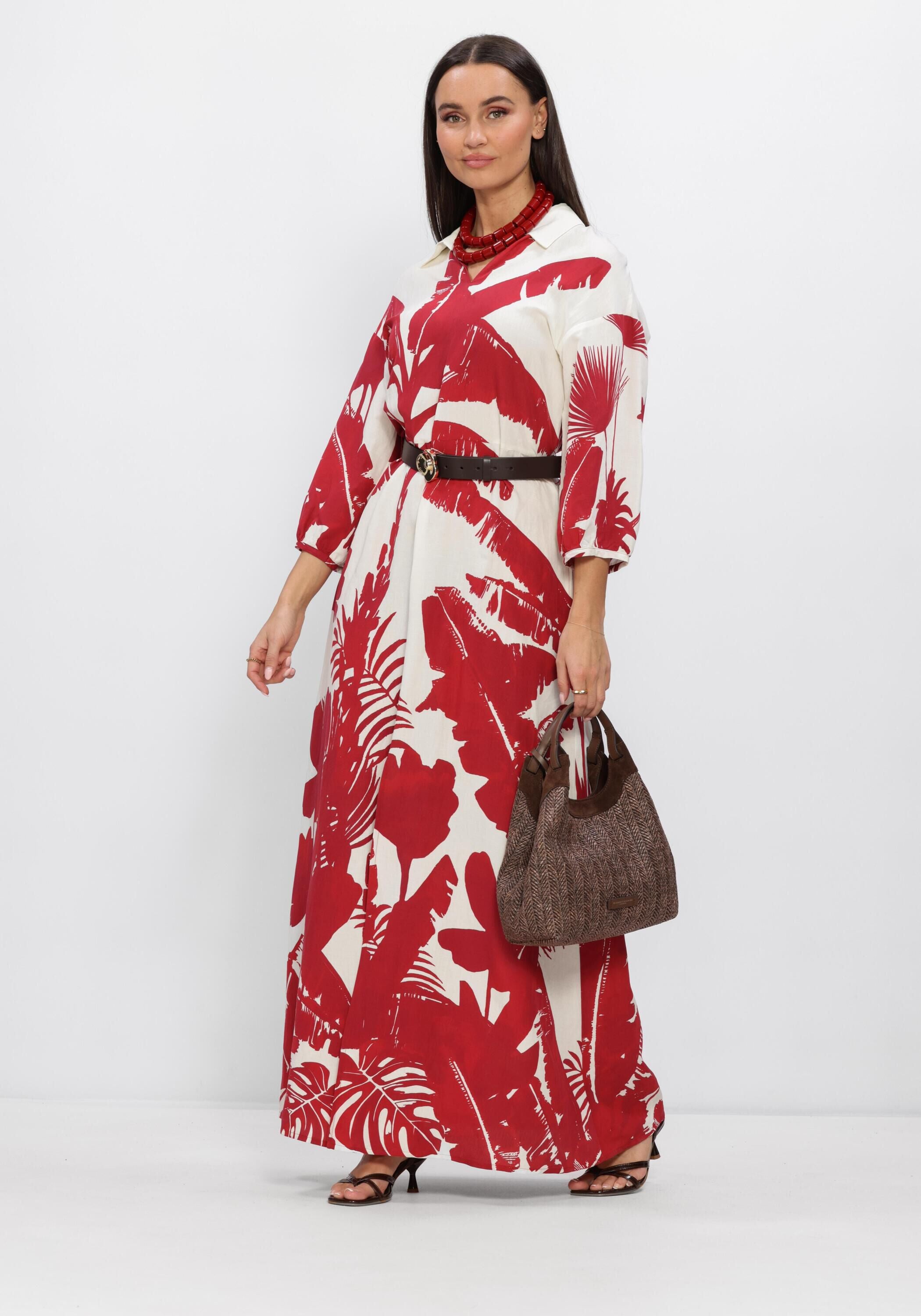Pink Baby Marcia tropical print maxi dress in red and white with flowy fabric and sleeveless design, suitable for warm weather.