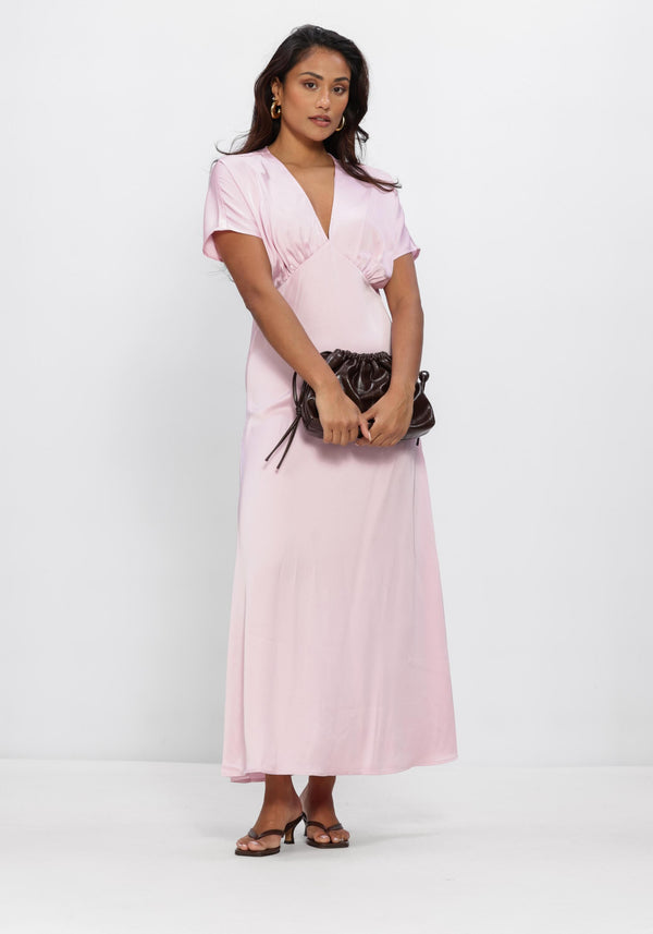 Pink Baby Juliana satin V-neck maxi dress in blush with flowing fabric and elegant design, shown on a hanger.