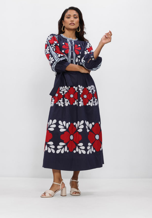 Pink Baby Elena navy floral embroidered midi dress with intricate embroidery and flowy fabric, perfect for elegant occasions.