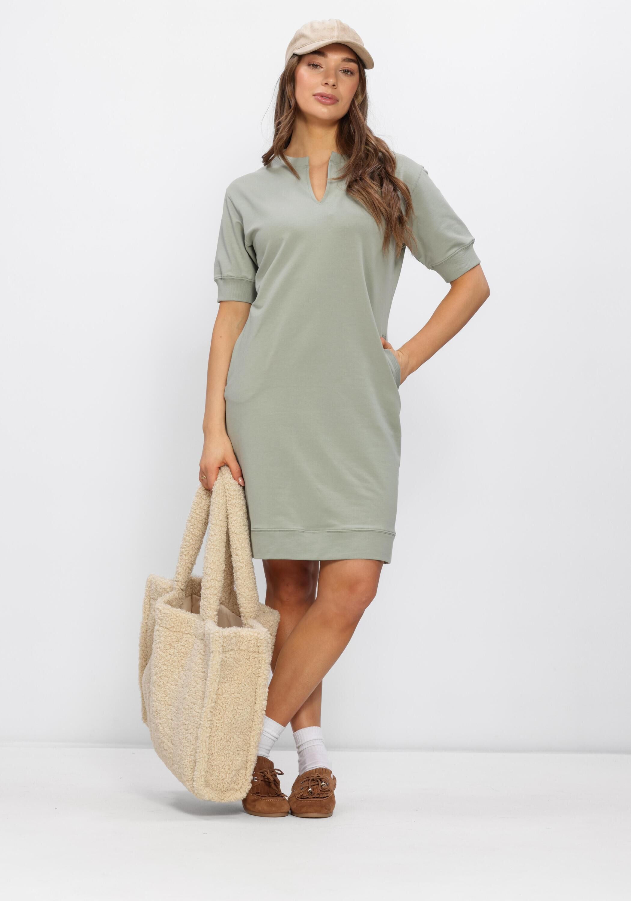 Pink Baby Solea relaxed notch-neck mini dress in sage green, featuring a fitted silhouette and short sleeves.