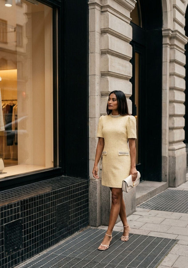 Pink Baby Celine embellished yellow tweed mini dress with intricate embroidery and soft pastel tones, stylish and elegant for special occasions.
