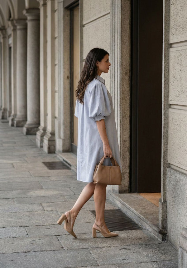 Pink Baby Adelina striped puff-sleeve shirt dress in white and black, featuring a fitted bodice and stylish puff sleeves.