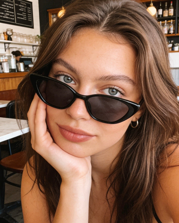 Pink Baby The Juno black sunglasses with sleek frames and tinted lenses, stylish eyewear for sun protection.