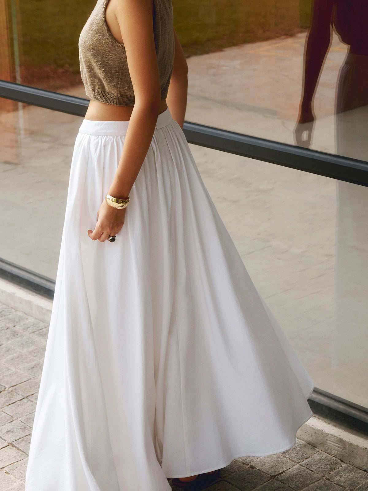 Pink Baby linen pleated maxi skirt displayed on a hanger, showcasing its flowing fabric and elegant pleats.