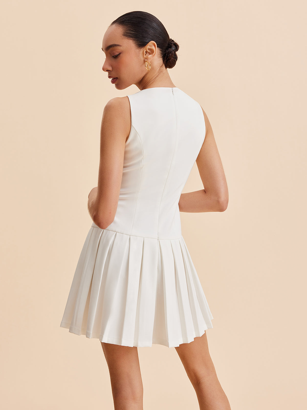 Pink Baby metal-button pleated tank dress with adjustable straps, lightweight fabric, and stylish design for casual or summer wear.