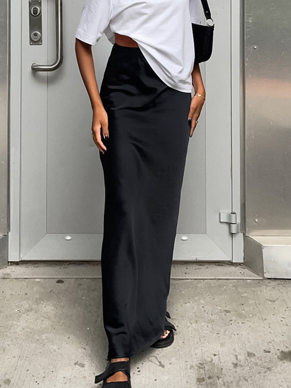 Pink Baby satin maxi skirt with utility design, flowing fabric and high waist, shown on a model in a casual setting.