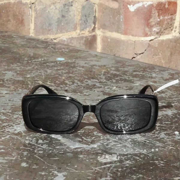 Pink Baby The Fern black sunglasses with sleek frame and dark lenses, stylish accessory for sun protection and fashion.