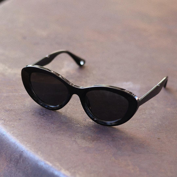 Pink Baby The Freesia black cat-eye polarized sunglasses with sleek frame and tinted lenses.