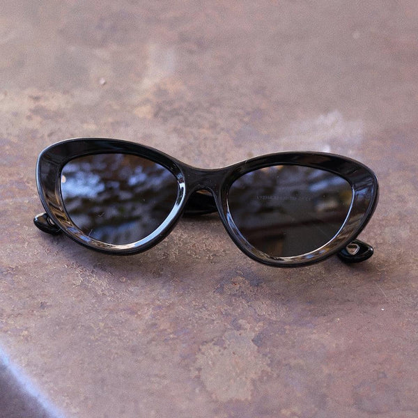 Pink Baby The Freesia black cat-eye sunglasses with tinted lenses and stylish frame, perfect for a fashionable look.