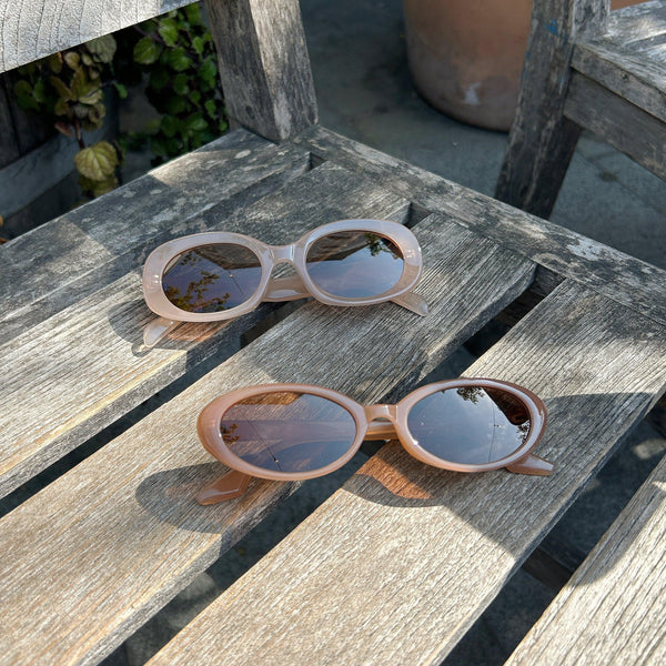 Pink Baby The Kyra cinnamon sunglasses with round frames and dark tinted lenses, stylish and protective eyewear for women.