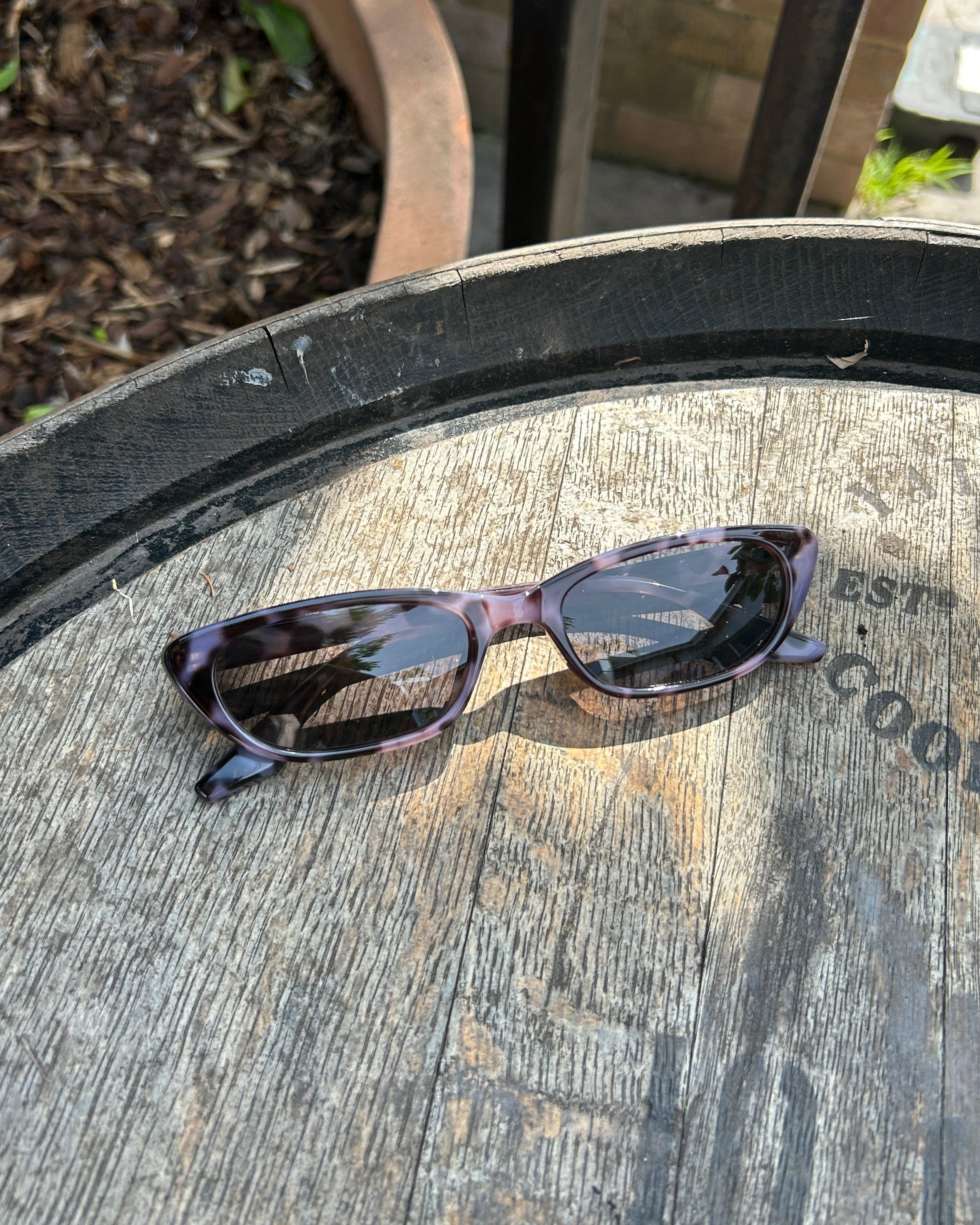 Pink Baby The Indie smoky sunglasses with round frames and dark tinted lenses, stylish and trendy accessory for sunny days.