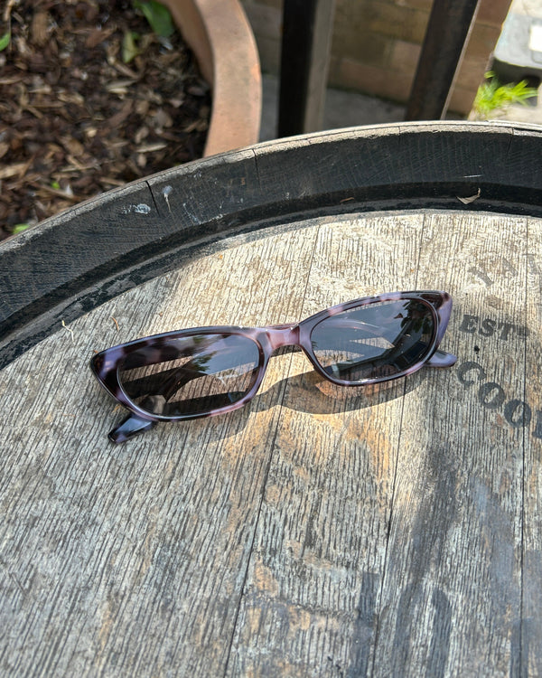Pink Baby The Indie smoky sunglasses with round frames and dark tinted lenses, stylish and trendy accessory for sunny days.