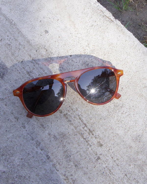 Pink Baby The Riley tort sunglasses with round frames and tinted lenses, stylish eyewear for sun protection.