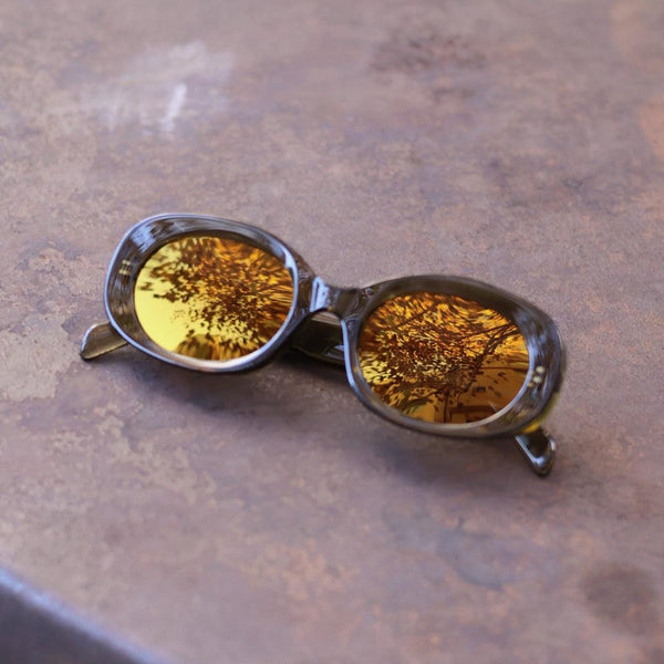 Pink Baby The Flynn olive sunglasses with round frames and dark lenses, stylish eyewear for a trendy look.
