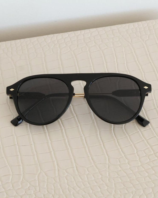 Pink Baby The Riley black sunglasses with rounded frames and dark lenses, stylish accessory for sunny days.