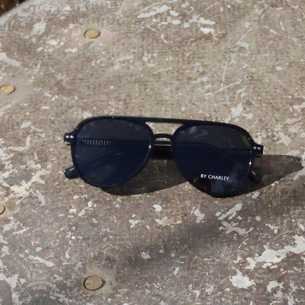 Pink Baby The Liam sunglasses with round frames and dark lenses, stylish eyewear for a modern look.